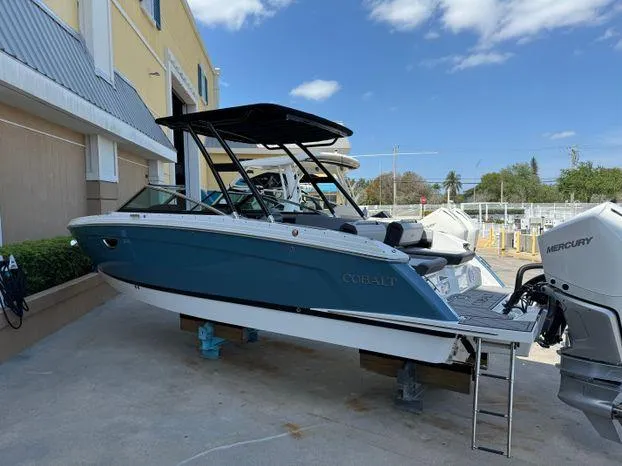 Slide: The Image of 2023 Cobalt R8 Outboard boat displayed outdoors, featuring sleek design and modern outboard engine. - 16