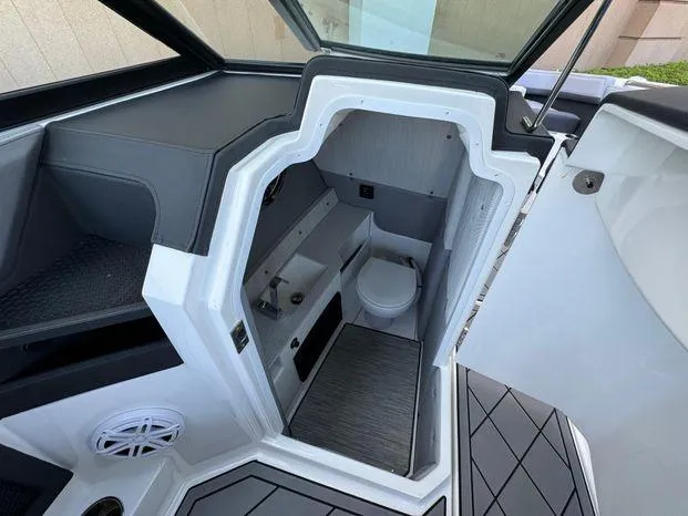 Slide: The Image of 2023 Cobalt R8 Outboard boat interior with compact bathroom and modern design. - 27