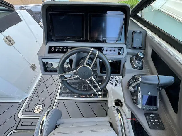 Slide: The Image of 2023 Cobalt R8 Outboard boat cockpit with modern steering and dual screens. - 31