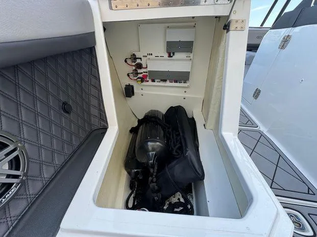 Slide: The Image of Storage compartment of 2023 Cobalt R8 Outboard boat with equipment and wiring. - 42