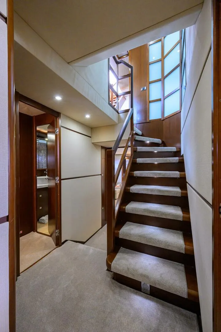 Slide: The Image of Interior staircase of 2009 Princess 95 yacht with modern design and wood accents. - 34