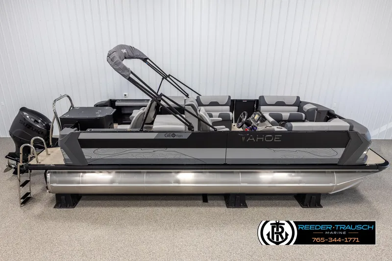 The Image of 2025 Tahoe TGO RF pontoon boat with Suzuki engine, displayed indoors. - 1