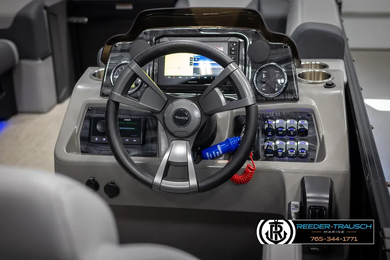 Slide: The Image of 2025 Tahoe TGO RF boat dashboard with steering wheel and control panel. - 24