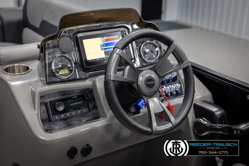 Slide: The Image of Steering console of 2025 Tahoe TGO RF boat with modern controls and display. - 25