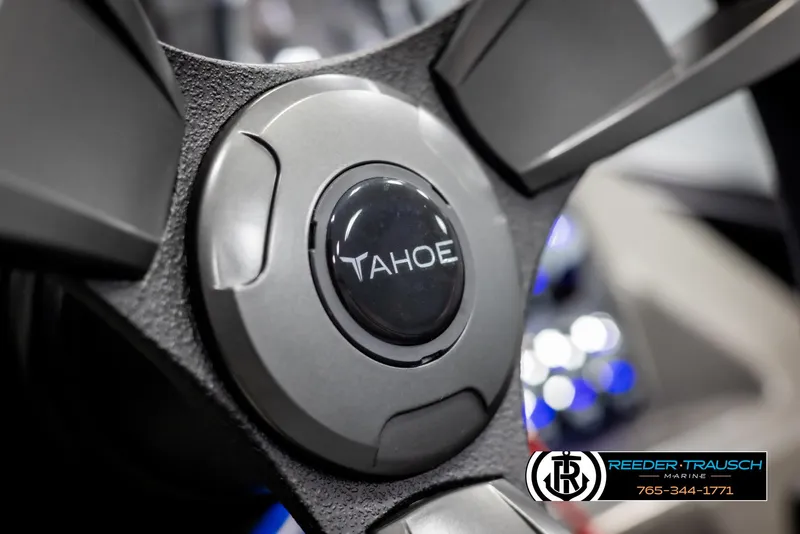 Slide: The Image of Steering wheel of 2025 Tahoe TGO RF boat, featuring Reeder-Trausch Marine logo. - 26