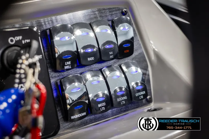 Slide: The Image of Control panel of 2025 Tahoe TGO RF boat with labeled switches and key ignition. - 30