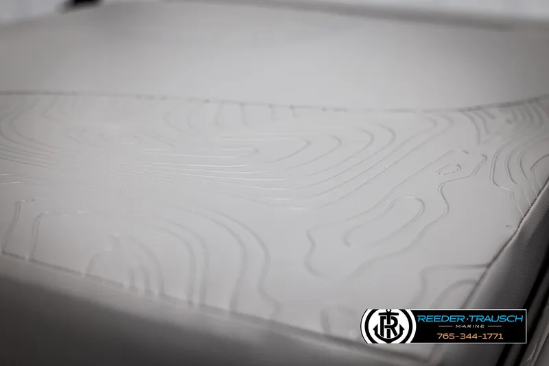 Slide: The Image of 2025 Tahoe TGO RF boat seat with embossed topographic design, Reeder-Trausch Marine logo visible. - 34