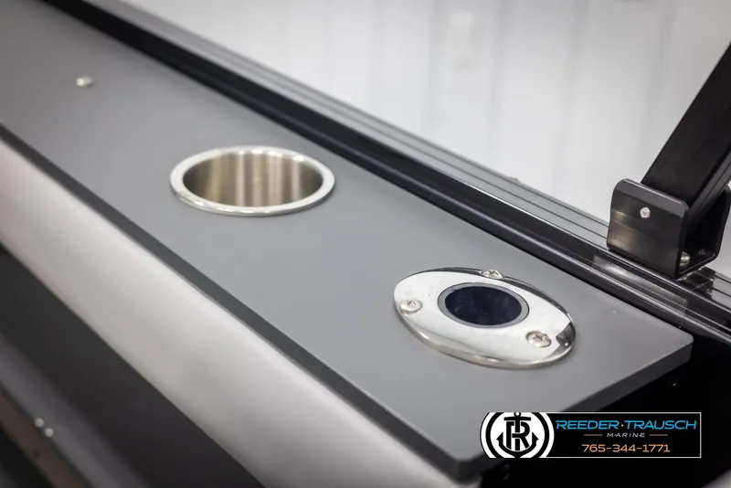 Slide: The Image of 2025 Tahoe TGO RF boat interior with cup holder and sleek design. - 37