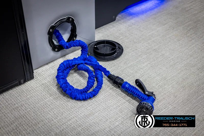 Slide: The Image of Blue coiled hose with nozzle on Tahoe TGO RF 2025 boat interior. - 40