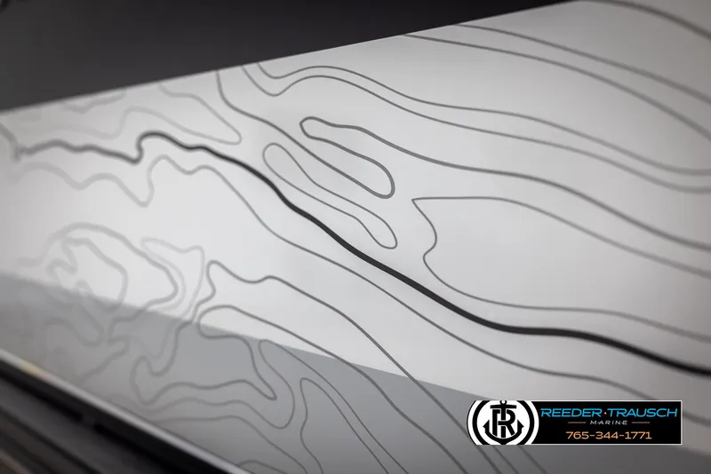 Slide: The Image of Abstract contour lines on 2025 Tahoe TGO RF boat panel, Reeder-Trausch Marine logo visible. - 49