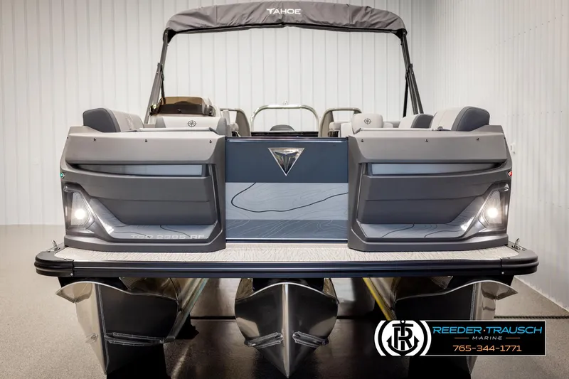 Slide: The Image of 2025 Tahoe TGO RF pontoon boat, sleek design, displayed indoors at Reeder-Trausch Marine. - 8
