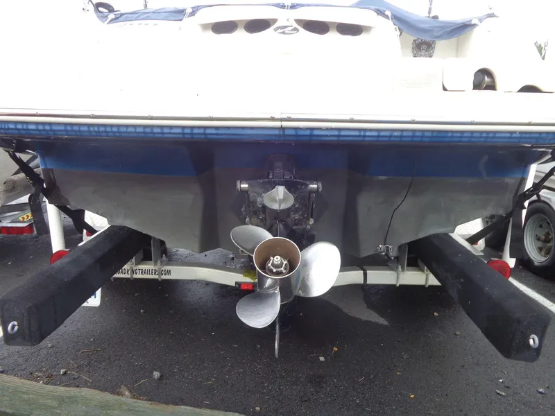 Slide: The Image of 2007 Sea Ray 200 Sundeck boat on trailer, rear view with propeller visible. - 12