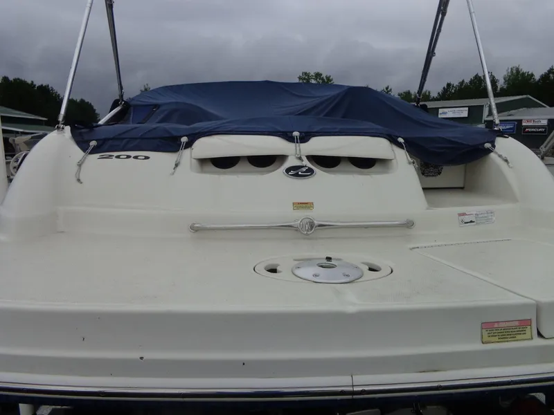Slide: The Image of 2007 Sea Ray 200 Sundeck boat with blue cover, rear view. - 14