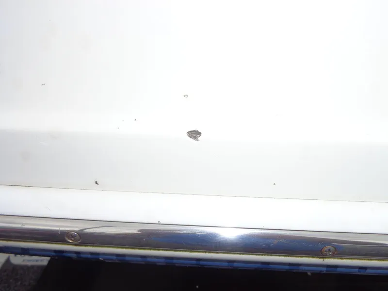 Slide: The Image of Close-up of a 2007 Sea Ray 200 Sundeck with a small hull chip. - 15