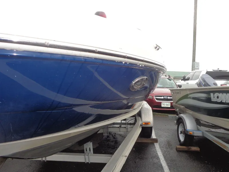 Slide: The Image of 2007 Sea Ray 200 Sundeck boat on trailer in parking lot. - 20