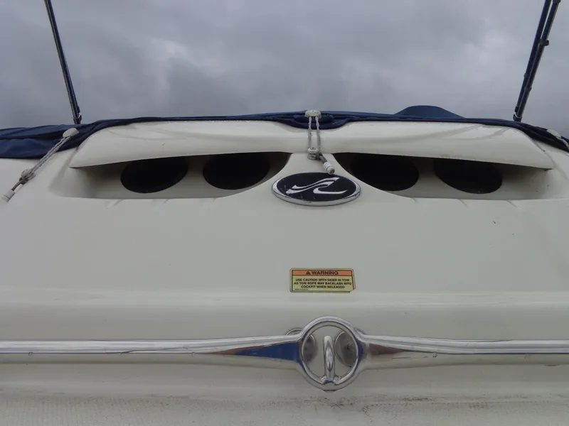 Slide: The Image of 2007 Sea Ray 200 Sundeck boat with logo and warning label, under cloudy sky. - 22