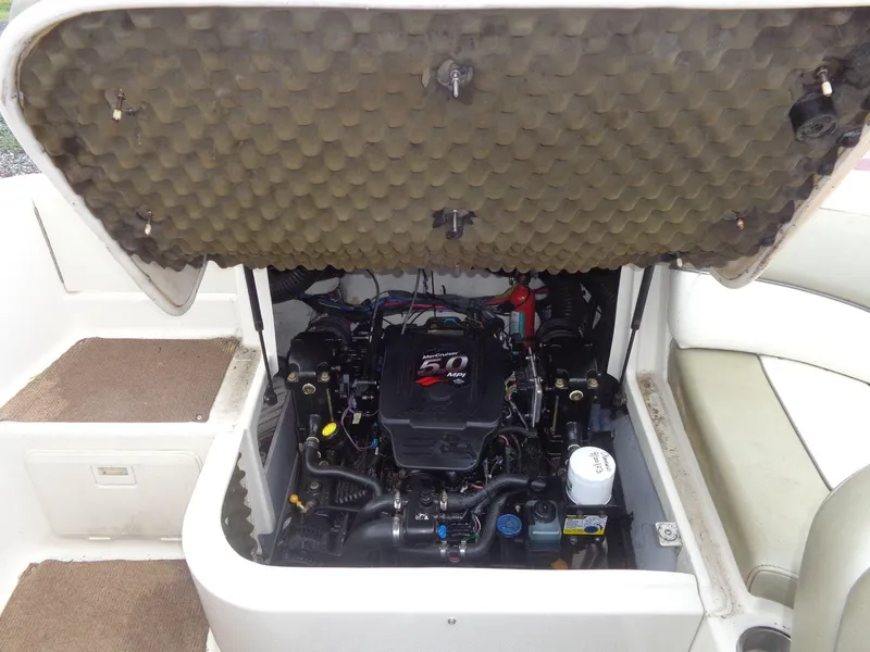 Slide: The Image of Engine compartment of a 2007 Sea Ray 200 Sundeck boat, showcasing the MerCruiser engine. - 26