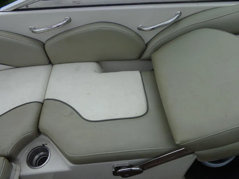 Slide: The Image of 2007 Sea Ray 200 Sundeck boat seating with beige upholstery and chrome handles. - 29