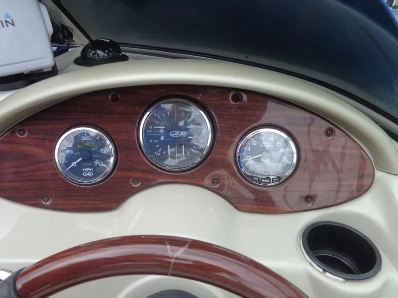 Slide: The Image of Dashboard of a 2007 Sea Ray 200 Sundeck boat with wooden panel and gauges. - 36