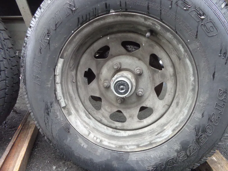 Slide: The Image of Close-up of a worn trailer wheel for a 2007 Sea Ray 200 Sundeck. - 8