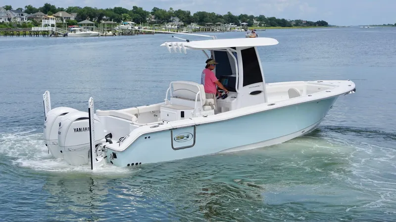 Slide: The Image of 2024 Sea Hunt Ultra 265 SE boat cruising on calm waters. - 2