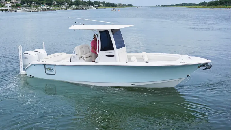 Slide: The Image of 2024 Sea Hunt Ultra 265 SE boat cruising on a calm waterway. - 3