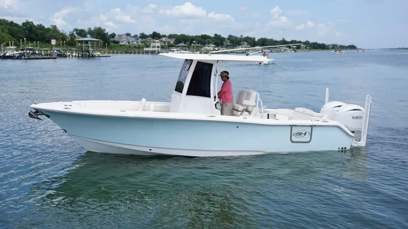 Slide: The Image of 2024 Sea Hunt Ultra 265 SE boat cruising on a calm lake. - 5
