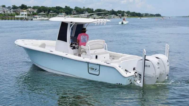 Slide: The Image of 2024 Sea Hunt Ultra 265 SE boat cruising on a calm waterway. - 6