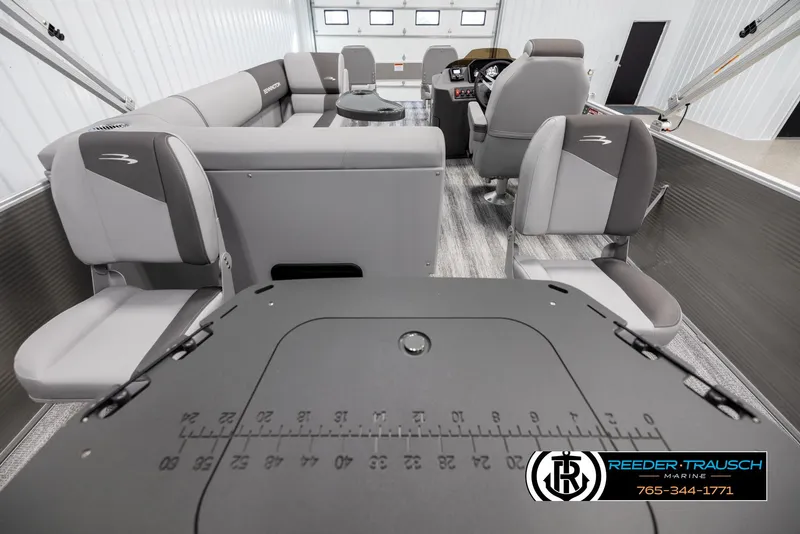 Slide: The Image of 2025 Bennington 21 SFSE boat interior with gray seating and modern dashboard. - 16