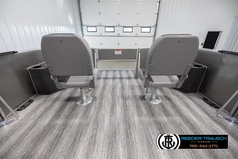 Slide: The Image of 2025 Bennington 21 SFSE boat interior with two gray seats and carpeted flooring. - 18