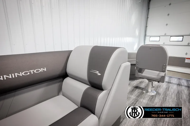 Slide: The Image of 2025 Bennington 21 SFSE boat interior with gray seating in a showroom. - 20