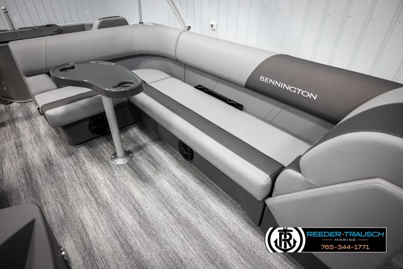 Slide: The Image of 2025 Bennington 21 SFSE boat interior with gray seating and table, Reeder-Trausch Marine logo. - 22