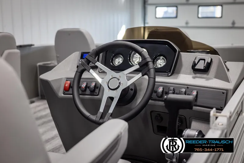 Slide: The Image of 2025 Bennington 21 SFSE boat dashboard with steering wheel and control panel. - 26