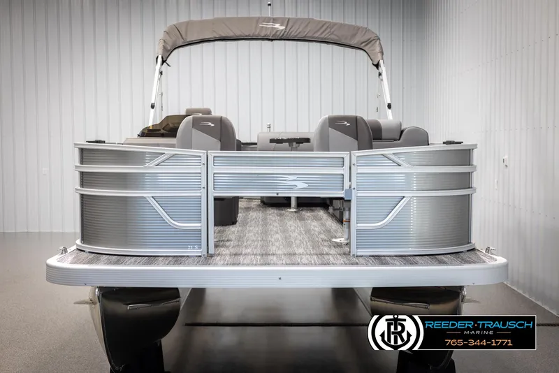 Slide: The Image of 2025 Bennington 21 SFSE pontoon boat in showroom, featuring sleek silver design and modern seating. - 8