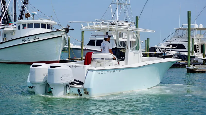 The Image of 2005 Southport 28 Center Console boat in marina, featuring twin engines. - 1