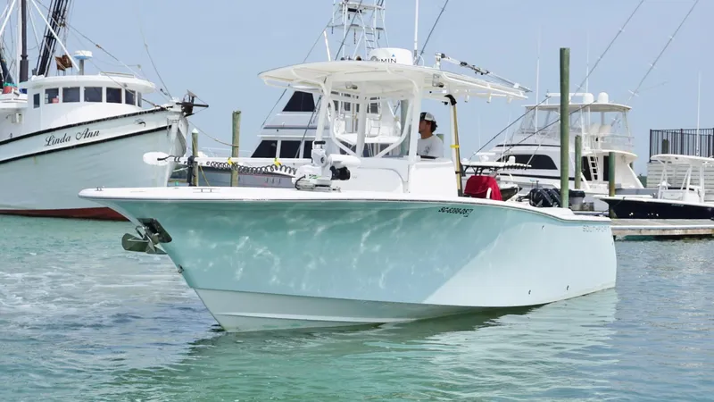 Slide: The Image of 2005 Southport 28 Center Console boat docked in marina, clear sky, calm water. - 3
