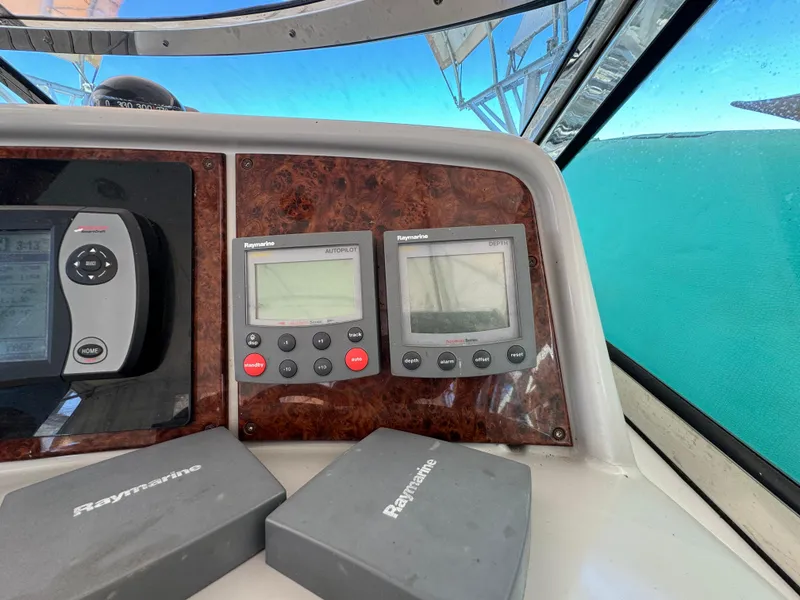 Slide: The Image of Control panel of a 2004 Formula 37 Performance Cruiser with Raymarine navigation equipment. - 12