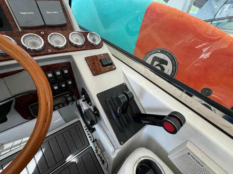 Slide: The Image of 2004 Formula 37 Performance Cruiser helm with wood accents and control panel. - 13