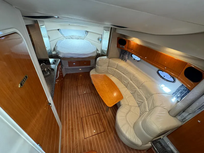 Slide: The Image of 2004 Formula 37 Performance Cruiser interior with wood flooring, leather seating, and compact kitchen. - 17