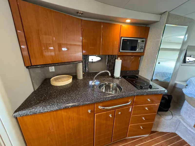 Slide: The Image of 2004 Formula 37 Performance Cruiser kitchen with wood cabinets and modern appliances. - 19