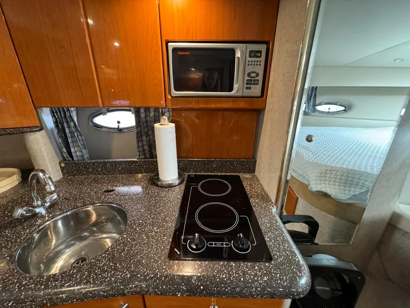 Slide: The Image of 2004 Formula 37 Performance Cruiser kitchen with sink, stove, and microwave. - 21