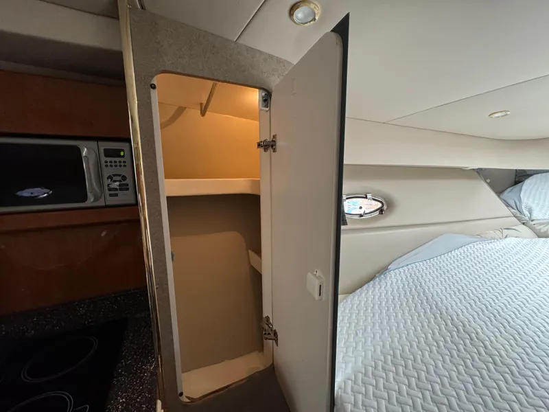 Slide: The Image of Interior of 2004 Formula 37 Performance Cruiser with open cabinet and bed. - 24