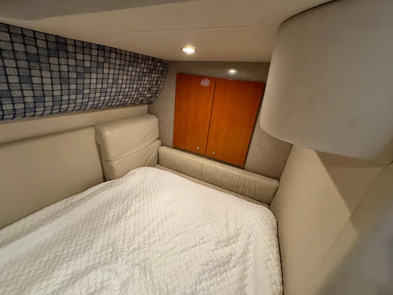 Slide: The Image of Interior cabin of 2004 Formula 37 Performance Cruiser with cozy bed and wooden cabinets. - 30