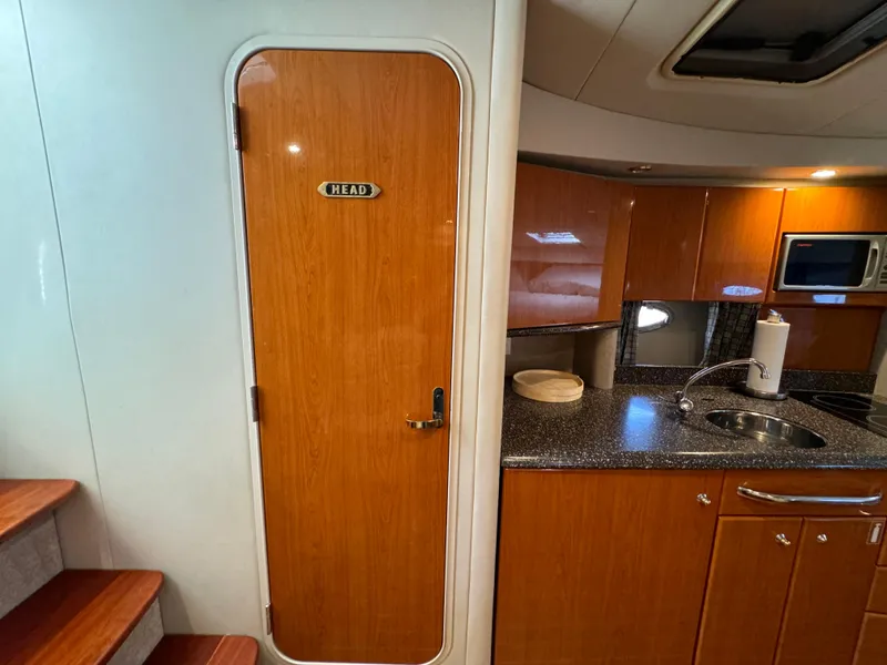 Slide: The Image of 2004 Formula 37 Performance Cruiser interior with kitchenette and head door. - 32