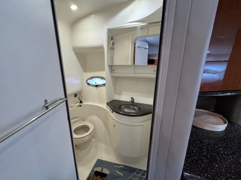 Slide: The Image of 2004 Formula 37 Performance Cruiser bathroom with sink, toilet, and mirror. - 33