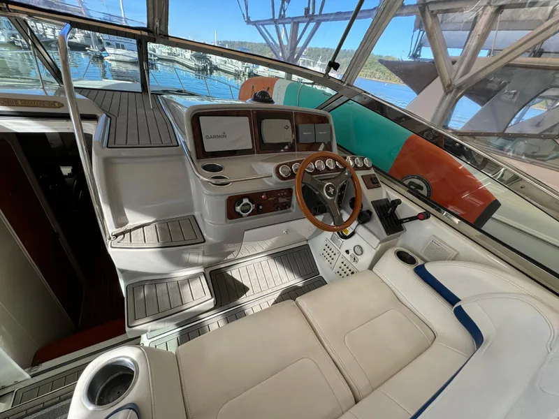 Slide: The Image of 2004 Formula 37 Performance Cruiser cockpit with steering wheel, navigation system, and seating. - 9