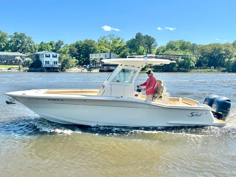 The Image of 2019 Scout 255 LXF boat cruising on a sunny river. - 0