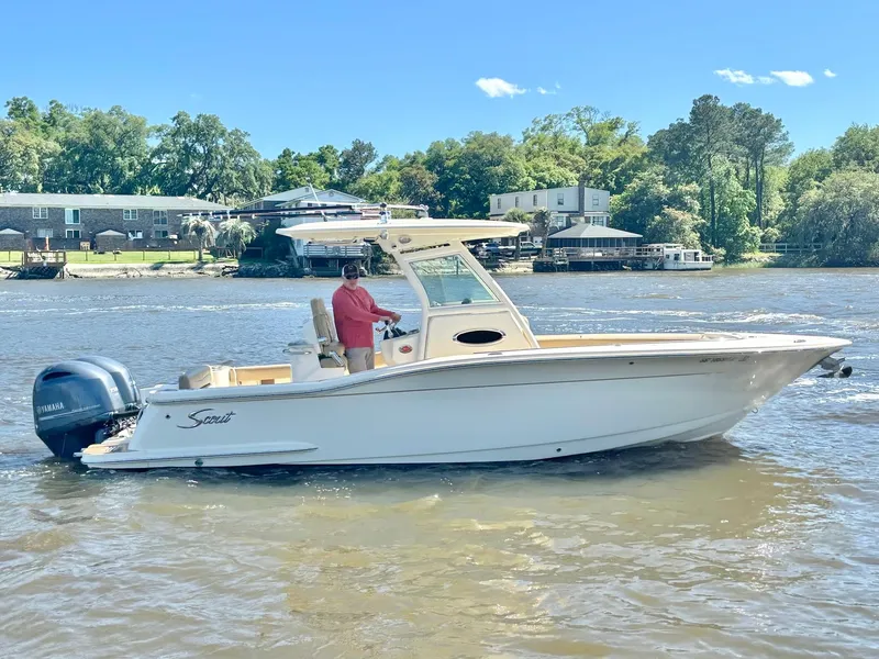 Slide: The Image of 2019 Scout 255 LXF boat cruising on a sunny river. - 4