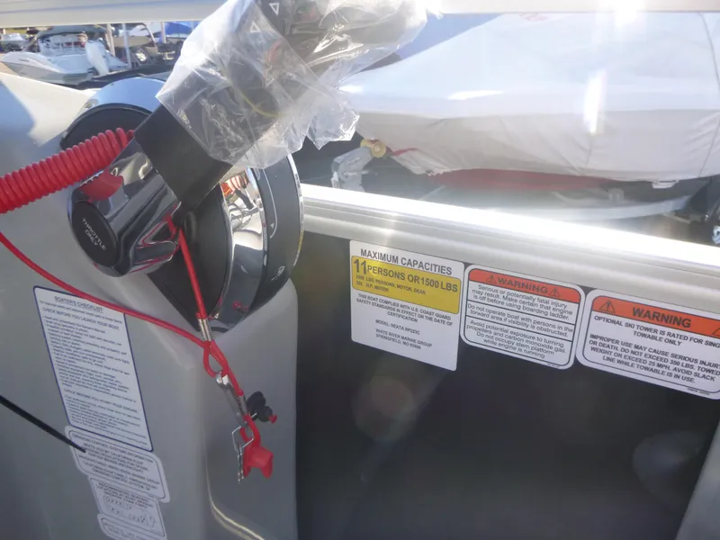 Slide: The Image of 2024 Ranger Reata 223C boat control panel with safety warnings and capacity details. - 17