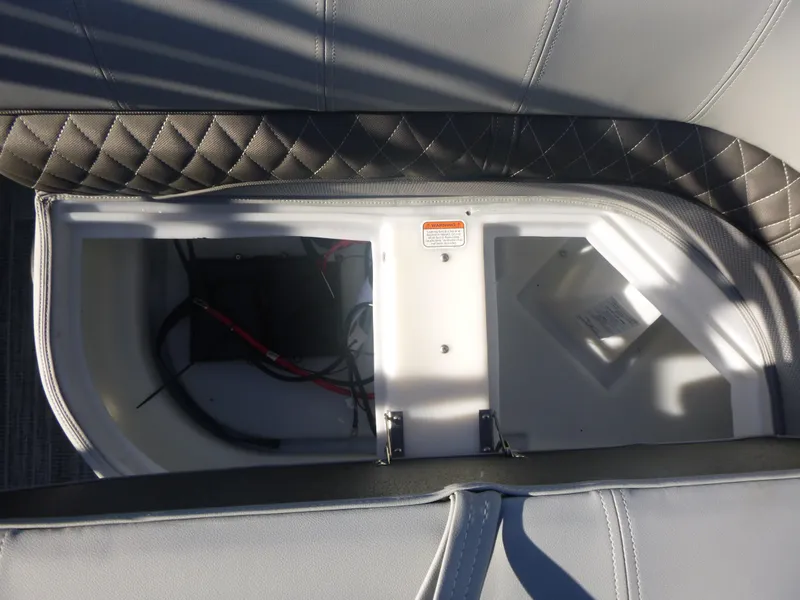 Slide: The Image of 2024 Ranger Reata 223C boat storage compartment with wiring and quilted upholstery. - 20